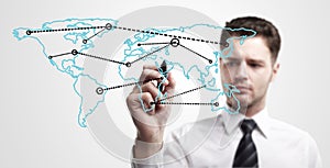 Young business man drawing a global network