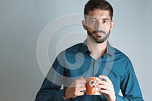 Young business man drinking coffee / tea