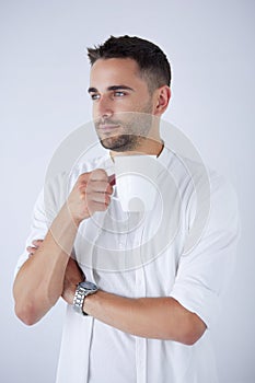 Young business man drinking a cup of coffee or tea
