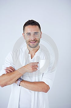 Young business man drinking a cup of coffee or tea