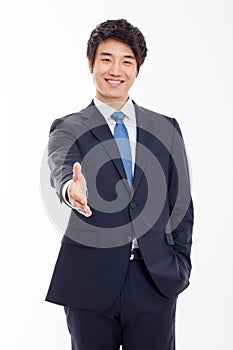 Young business man extending hand to shake