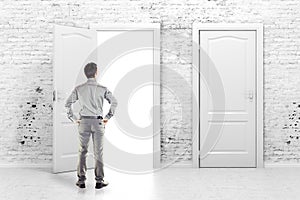 Young business man in front of an open door