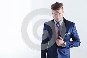 Young business man with hand on jacket lapel