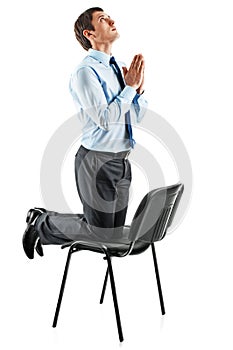Young business man on his knees praying