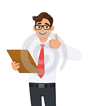 Young business man holding clipboard and showing thumbs up sign. Trendy person keeping notepad, document or folder. Male character