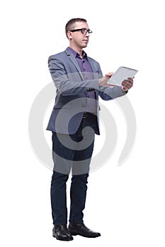 Young business man holding a tablet and showing thumb up while smiling to the camera