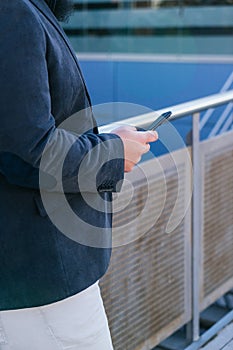 young business man looking phone near to office