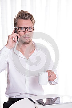 Young business man on the phone looking scared