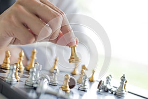 A young business man is playing chess, business strategy to be successful