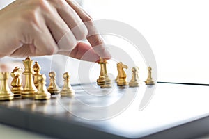 A young business man is playing chess, business strategy to be successful