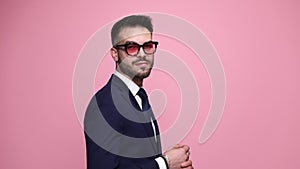 young business man posing on pink background