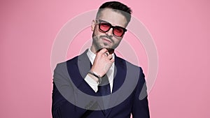 young business man posing on pink background