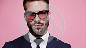 young business man posing on pink background