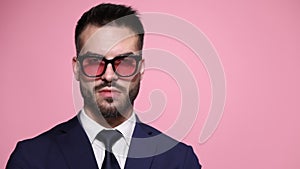 young business man posing on pink background