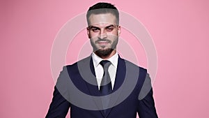 young business man posing on pink background