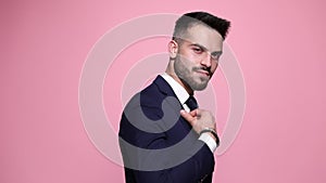 young business man posing on pink background