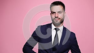 young business man posing on pink background
