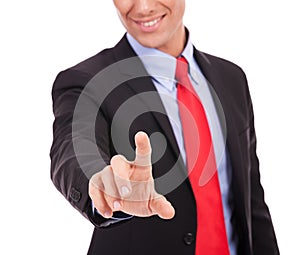 Young business man pushing a button