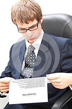 Young business man reading a curriculum vitae