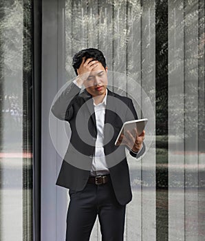 Young business man reading document of decline in sales after Covid-19 pandemic