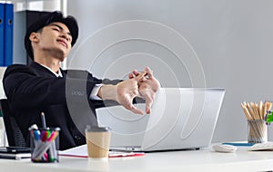 Young business man relaxing in office, man sit relax at office workplace, male rest in chair distracted from computer work
