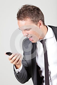 Young business man screaming in his cellphone