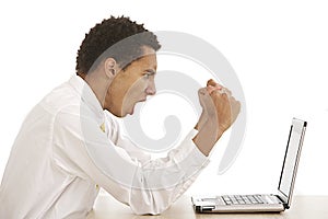 Young business man shouting at his laptop