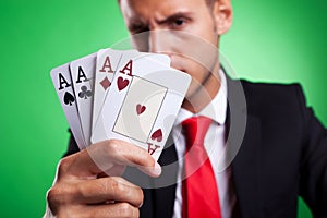 Young business man showing four aces