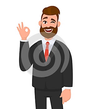 Young business man showing OKAY/OK sign gesturing hand. Emotion and body language concept.