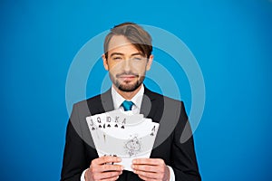 Young business man showing playing cards