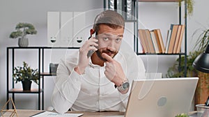 Young business man showing smartphone asking to make telephone conversation gesturing call me sign