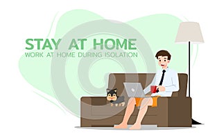 Young business man is sitting and working with laptop on the sofa at home with his dog. Online job in social for safety and to pro