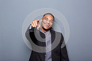 Young business man smiling and pointing finger