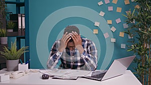 Young business man sorting out financial charts on papers