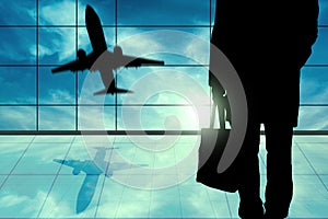 Young business Man Standing In Front of Airport window View. Man inside Airport hall with windows glass