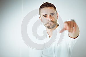 Young business man standing isolated on white background