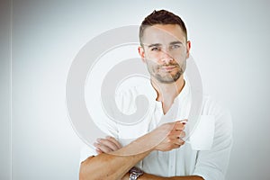 Young business man standing isolated on white background