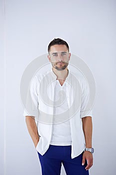 Young business man standing isolated on white background