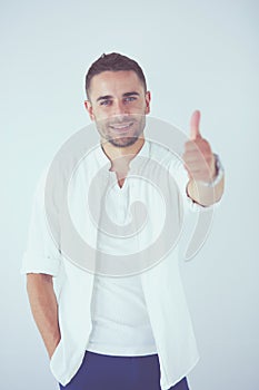 Young business man standing isolated on white background.