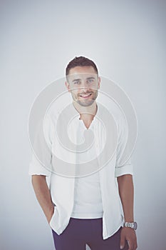 Young business man standing isolated on white background.