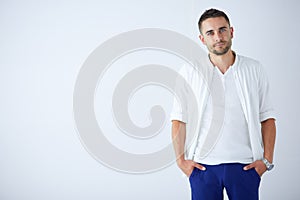 Young business man standing isolated on white background.