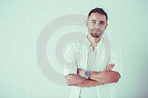 Young business man standing isolated on white background.