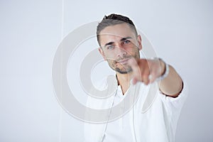 Young business man standing isolated on white background.
