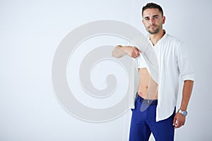 Young business man standing isolated on white background.