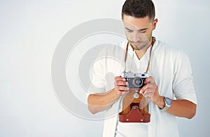 Young business man standing isolated on white background.