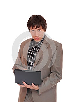 Young business man standing with laptop