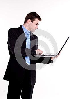 Young business man standing with laptop