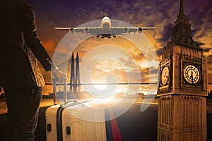 Young business man standing with luggage on urban airport runway