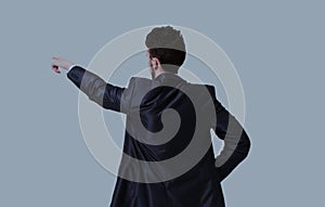 Young business man in a suit pointing with his finger