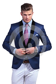 Young business man taking suit jacket off